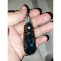 Long costume blue looking pendant