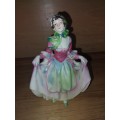 Vintage lady figurine with a pink dress