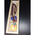 Long beaded necklace with interesting yellow pendant