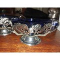 A pair of sliver plated chrome dishes with blue glass inners