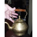 A nice medium sized brass  kettle with wooden handle