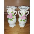 A pair of small floarl procelain vases