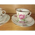 A pair of pretty rose tea cup trios