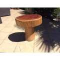 A mushroom shaped tree stump side table or foot stool