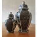 Japanese Meiji style Vases with lids on wooden bases.