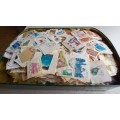 CHOCOLATE TIN FULL OF STAMPS ON PAPER - MIXED WORLD