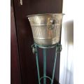 ICE BUCKET ON PAINTED WRAUGHT IRON STAND-THE BUCKET IS PLATED SILVER WITH A DIAMETER OF 24 CM AT THE