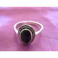 A SOLID SILVER MARCASITE RING WITH A BLACK STONE--NEW