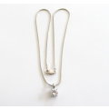 A SOLID SILVER PENDANT ON A SILVER SNAKE CHAIN PLUS SIMILAR PLATED EARRINGS