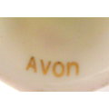 AN AVON THIMBLE SURROUNDED BY FLOWERS