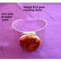 A HEAVY WIDE STERLING SILVER BANGLE WITH A LARGE JASPER STONE---83,9 gram including stone