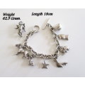 A HEAVY SOLID SILVER CHARM BRACELET WITH LARGE AND MEDIUM SIZE CHARMS--62,5 Gram