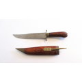 A KNIFE/DAGGER WITH A CARVED WOODEN SHEATH