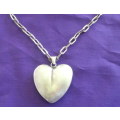 A 72cm LONG STERLING SILVER CHAIN WITH A STERLING SILVER HEART PENDANT