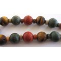 A LOVELY RUSTIC LOOKING MIXED SEMI-PRECIOUS STONE NECKLACE AND BRACELET--SET IN SILVER