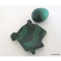 A SMALL MALACITE EGG ON A STAND