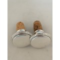An Outstanding Pair of Silver and Cork Wine Bottle Stoppers