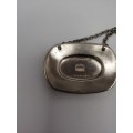 A VINTAGE SILVER PLATED DECANTER LABEL MARKED BRANDY