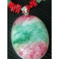 PRETTY GREEN PINK AND WHITE OVAL STONE? PENDANT ON A CORAL ?? AND SHELL CHAIN.