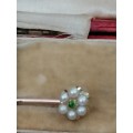A Stunning, classy gold pin set with  a small emerald surrounded by seed pearls in it`s original box