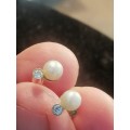 18ct yellow gold earrings set with pearls and small round cut diamonds . Ttl weight 1.7g pearl,5mm.