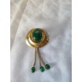 Very interesting gold tone brooch with green stones