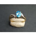 ** EXQUISITE:  9ct Yellow Gold and Oval Cut Blue Topaz Ring (1.46ct) w/ Two Melee Diamonds .**