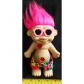 Collectable Troll doll with pink hair and a loving heart in a beach outfit