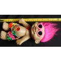 Collectable Troll doll with pink hair and a loving heart in a beach outfit