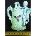 Porcelain vase in shape of watering can with figure and decoration.Retro kitsch