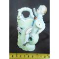 Porcelain vase in shape of watering can with figure and decoration.Retro kitsch