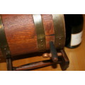 A GORGEOUS VINTAGE WOODEN WINE VAT ON A STAND WITH STUNNING BRASS STRAPS