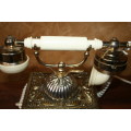 AN EXQUISITE VINTAGE ROTARY DIAL TELEPHONE WITH WHITE BAKELITE HANDLE AND EMBOSSED DETAILING