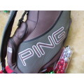 A GOOD CONDITION PING GOLF BAG WITH SOME GOLF CLUBS