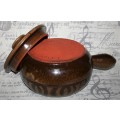 A Large vintage pottery bowl with a lid an explosion of color on both sides and a wonderful handle.