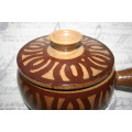 A Large vintage pottery bowl with a lid an explosion of color on both sides and a wonderful handle.