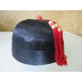 A GORGEOUS BLACK HAT WITH A RED TOSSEL FOR THE HAT COLLECTORS OR FOR THE NEXT HAT PARTY