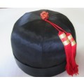 A GORGEOUS BLACK HAT WITH A RED TOSSEL FOR THE HAT COLLECTORS OR FOR THE NEXT HAT PARTY