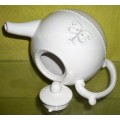 A STYLISH OFF WHITE TEA POT WITH STUNNING DESIGN THAT WILL MAKE A STATEMENT
