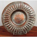 This is a fabulous retro copper plate with a stunning hammered motif .