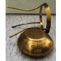 Ornate brass bowl on a stand holding a vase -  stunning of craftsmanship piece-  different