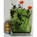 A heavy decorative flower Vase. It's made of an emerald green glass in a modern rectangular shape