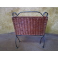 A LOVLEY WEAVED CANE AND METAL FOLD UP MAGAZINE RACK