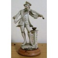 A DELIGHTFUL ITALIAN FIGURINE MOUNTED ON WOOD OF A MAN PLAYING THE VILON