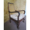 A GORGEOUS SOLID IMBUIA BOW BACKED BALL & CLAW ARM CHAIR WITH A RARE WEAVED RATTAN BACK