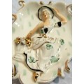 A charming wall hanging plaque featuring the portrait of a woman. It has been cast from porcelain