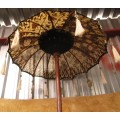 A BEAUTIFUL LONG INDIAN UMBRELLA DECORATED WITH BELS - TUSSLES EX