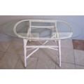 A VINTAGE CANE HIGH COFFEE TABLE WITH A OVAL GLASS TOP