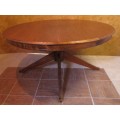 A VERY LARGE OVAL TO ROUND EXTENDABLE TABLE WITH BEAUTIFUL LEGS