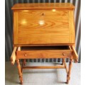 A VERY USEFUL SOLID WOOD WRITING DESK WITH BEAUTIFULL TURNED LEGS